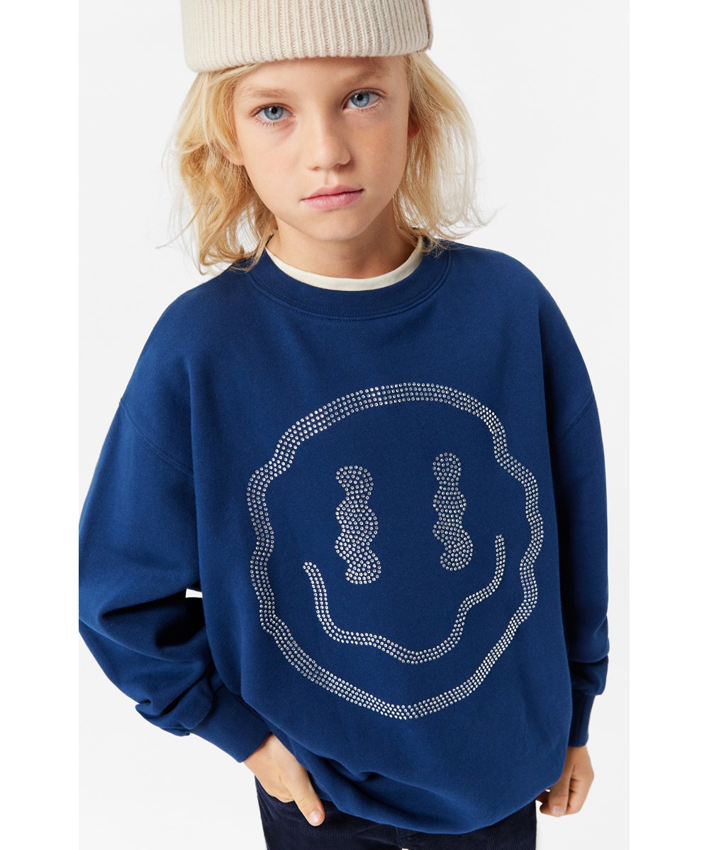 Monti - Bling Smile - Weiches und warmes dunkelblaues Öko-Baumwoll-Sweatshirt mit Pailletten-Kunstwerk.