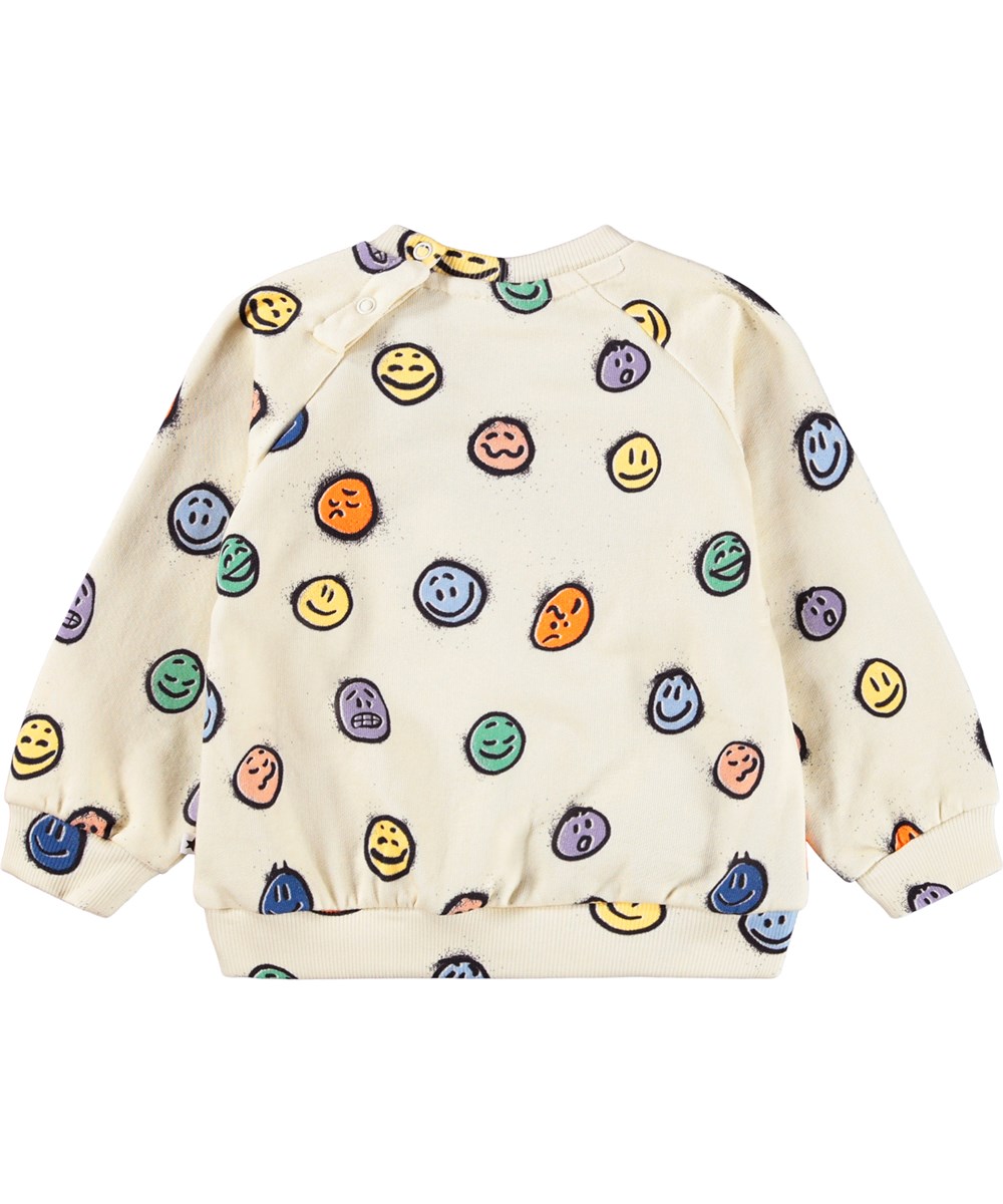 Disc - Multi Moods - Gebroken witte sweater voor de kleintjes gemaakt van zacht biologisch katoen met een kleurrijke print van gezichten in verschillende stemmingen.