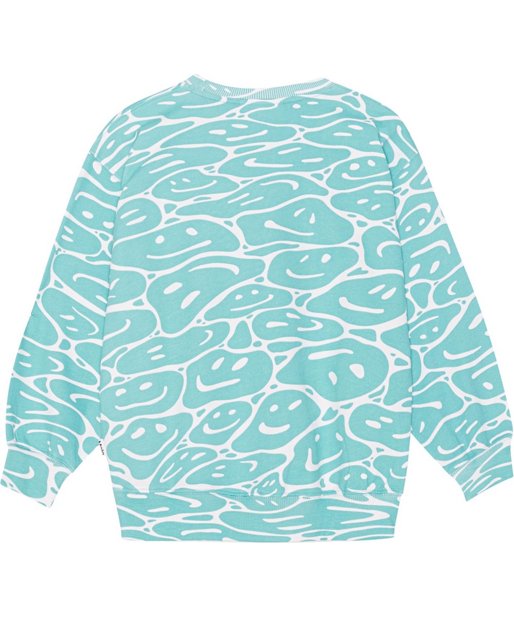Monti - Waves Of Joy - Biologische sweater in turquoise en wit met een print van smiley's die samensmelten