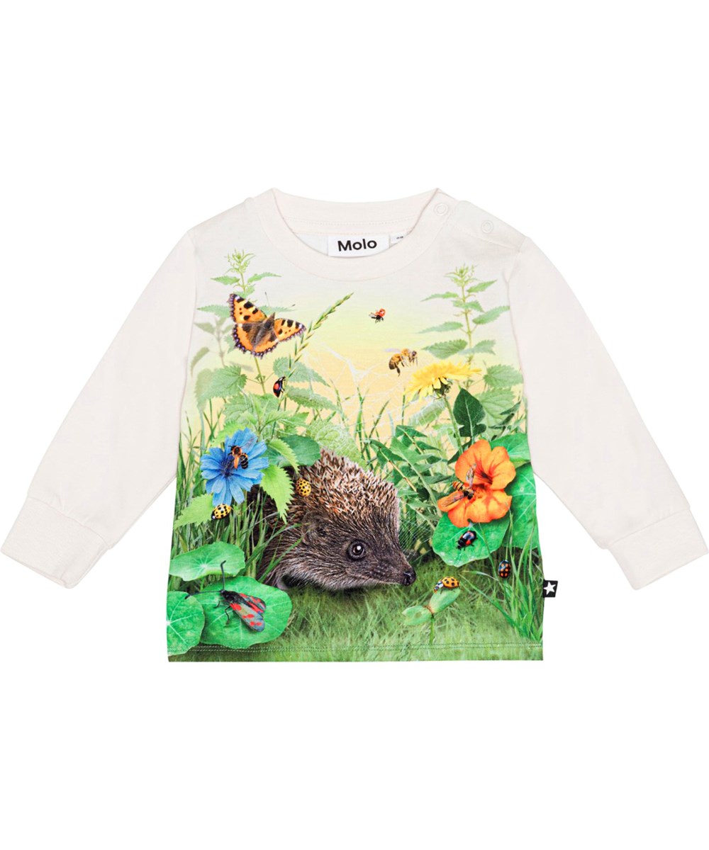 Eloy - Living Garden - Cremeweißes Langarmshirt für die Kleinen aus Öko-Baumwolljersey mit einem Aufdruck von Igeln und Insekten im grünen Gras