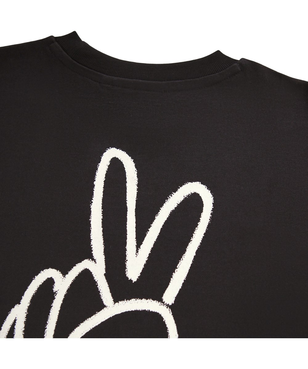 Rodney - Peaceful Hand - Schwarzes T-Shirt für Kinder aus weicher Bio-Baumwolle mit kurzen Ärmeln und einem gerippten Ausschnitt.