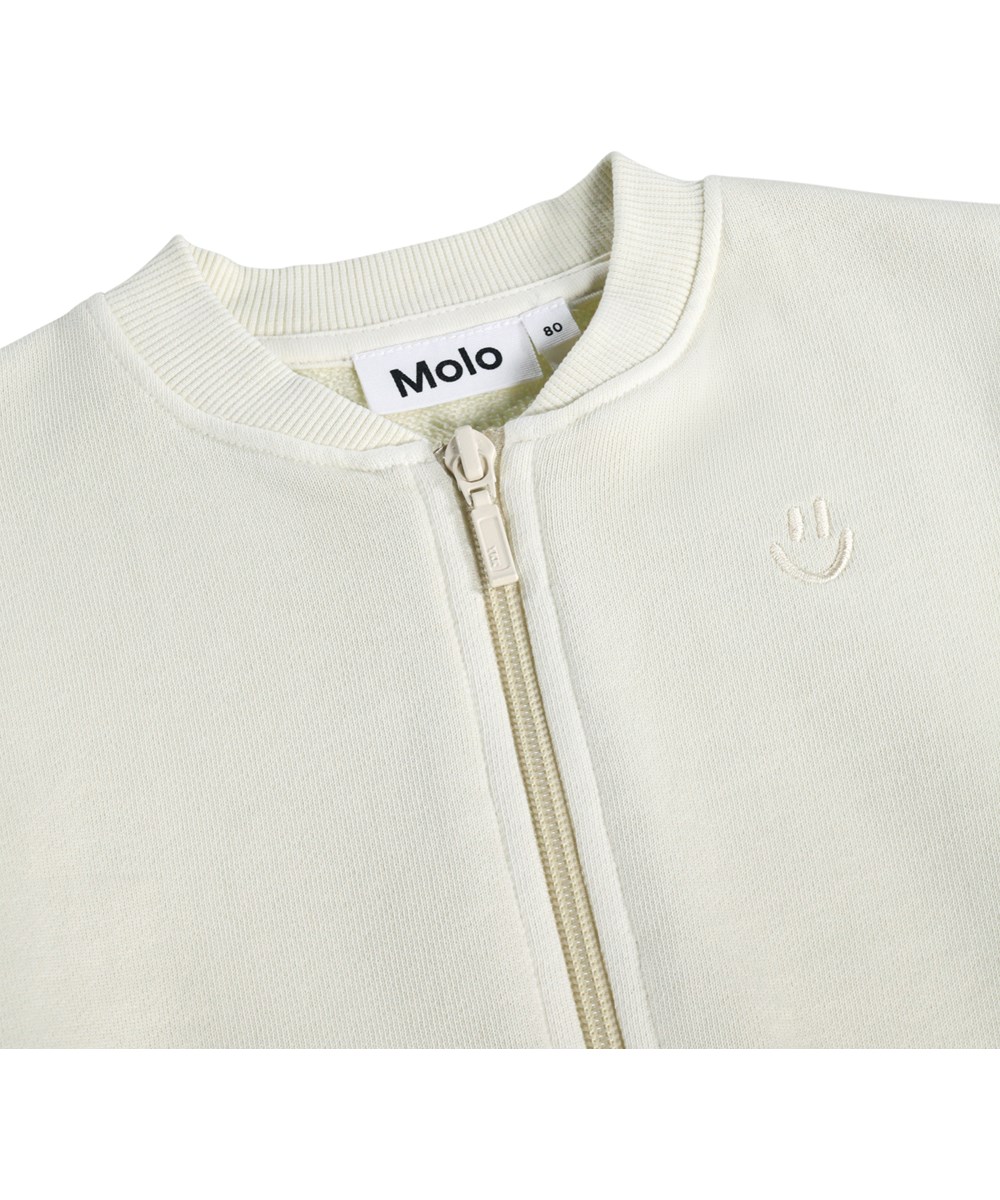 Dazzle - Summer Sand - Blød, hvid sweatshirt med lynlås i økologisk bomuld til baby 