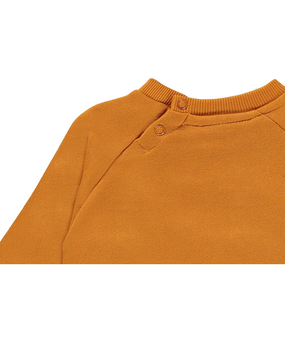 Disc - Old Gold - Økologisk orange babybluse med smiley print