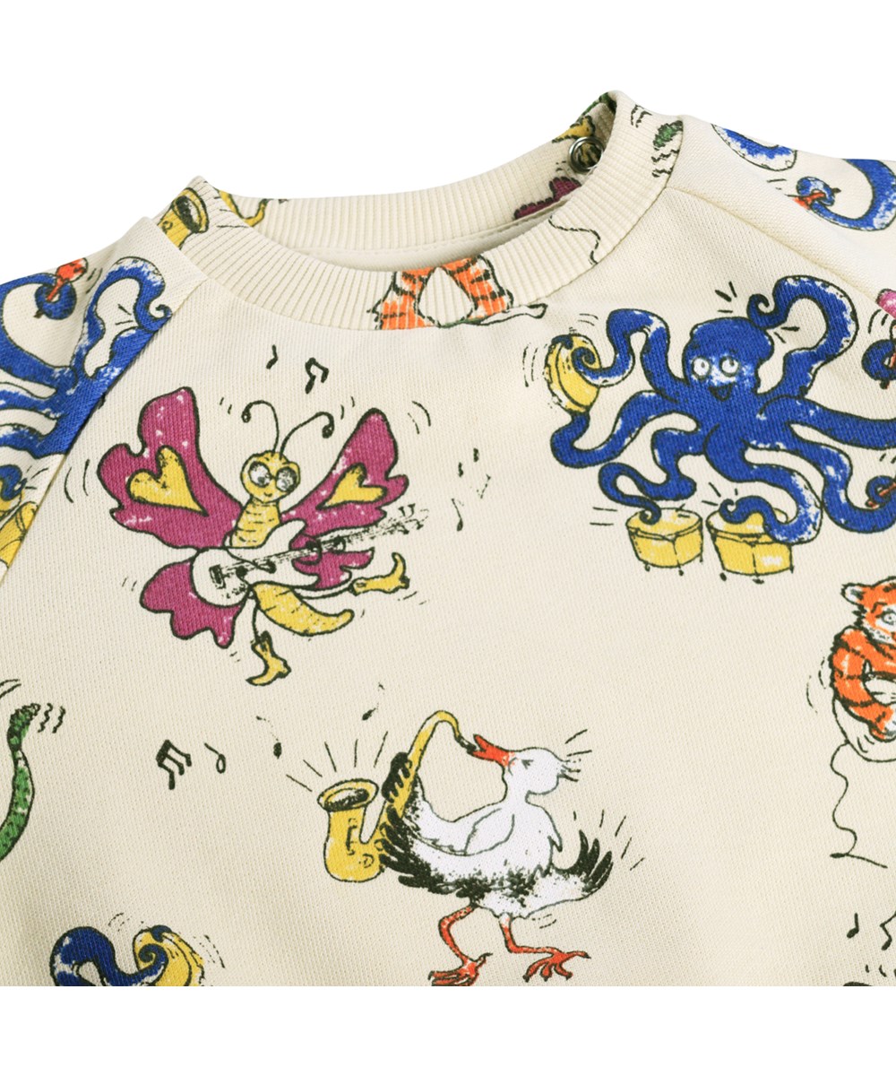 Disc - Rockin Animals - Blød, cremefarvet sweatshirt med musikprint i økologisk bomuld til baby 