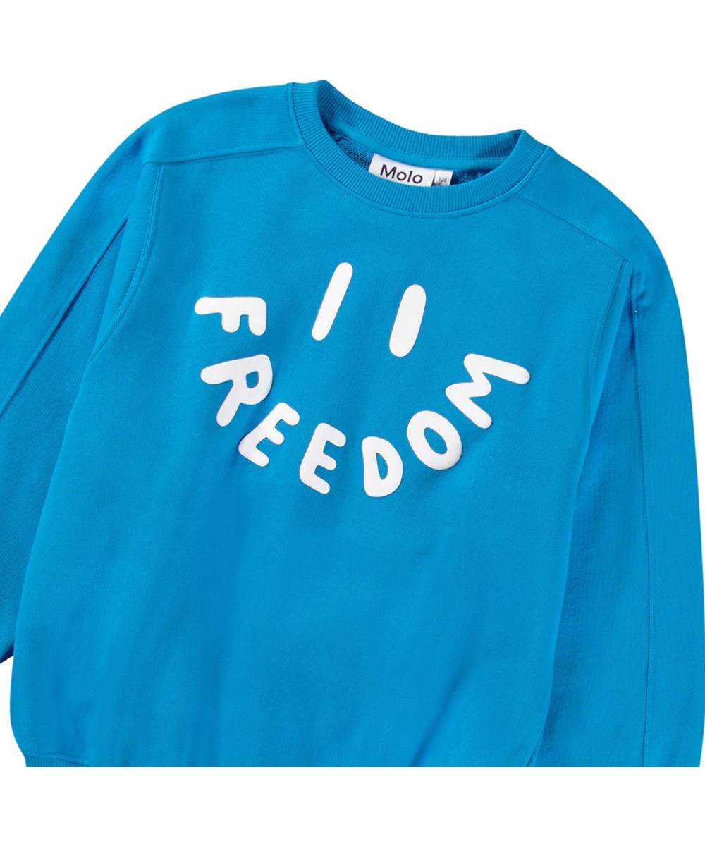 Mir - Peacock Blue - Blå sweatshirt med print til børn i blødt, økologisk bomuld med ribkanter ved hals, ærmer og i bunden af blusen.