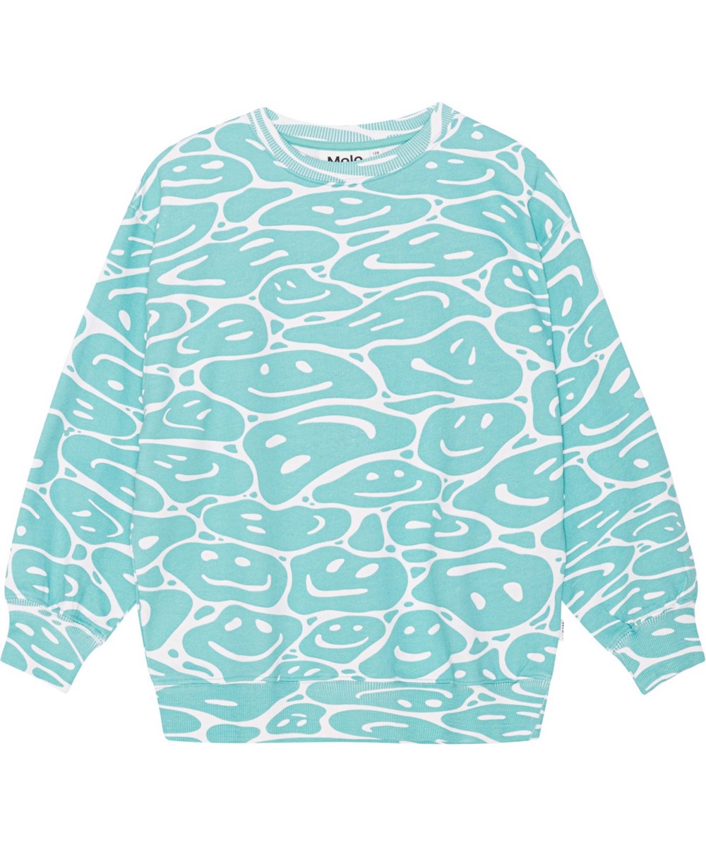 Monti - Waves Of Joy - Økologisk sweatshirt i turkisblå og hvide farver med et all over print af smilende ansigter der er smeltet sammen