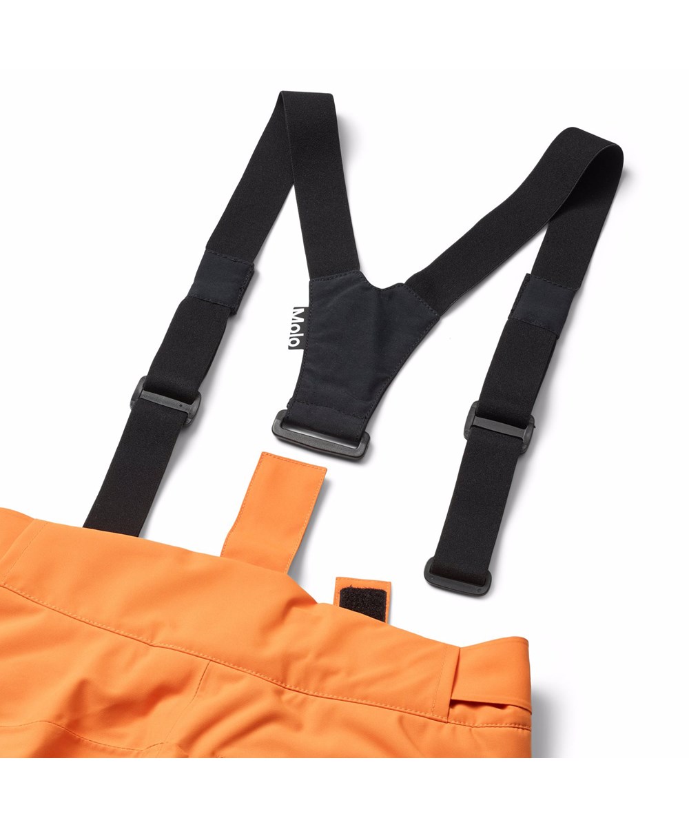 Jump Pro - Lava Orange - Oranje wind- en waterdichte kinderskibroek gemaakt van gerecycled polyester en gevoerd met 3M™ Thinsulate™.