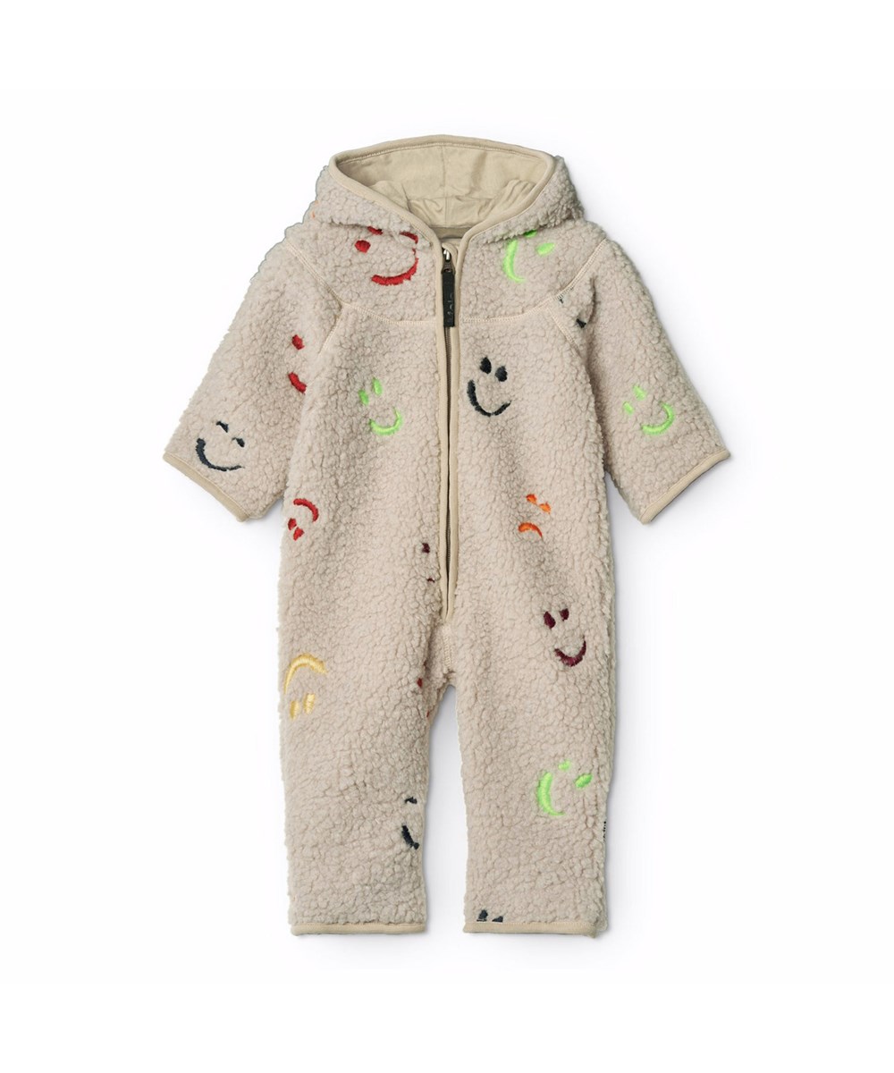 Umeko - Teddy Emotions - Beige fleecepak voor de kleintjes gemaakt van gerecycled polyester met geborduurde glimlachende gezichten in verschillende kleuren en zachte katoenen voering.