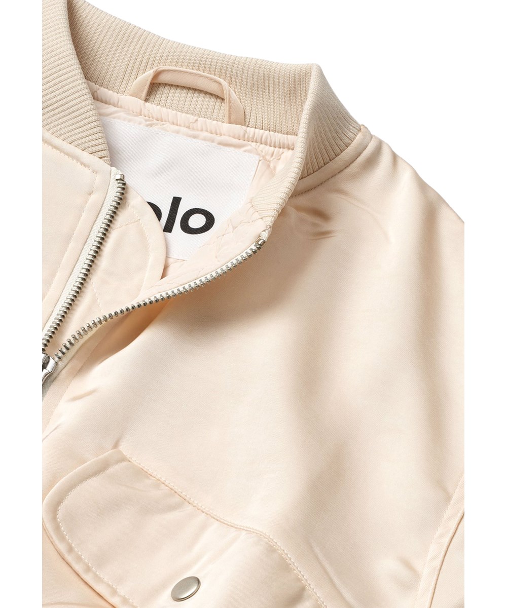 Hannie - Soft Powder - Off-white kort bomberjack voor kinderen met een lichte glans en gewatteerde voering.