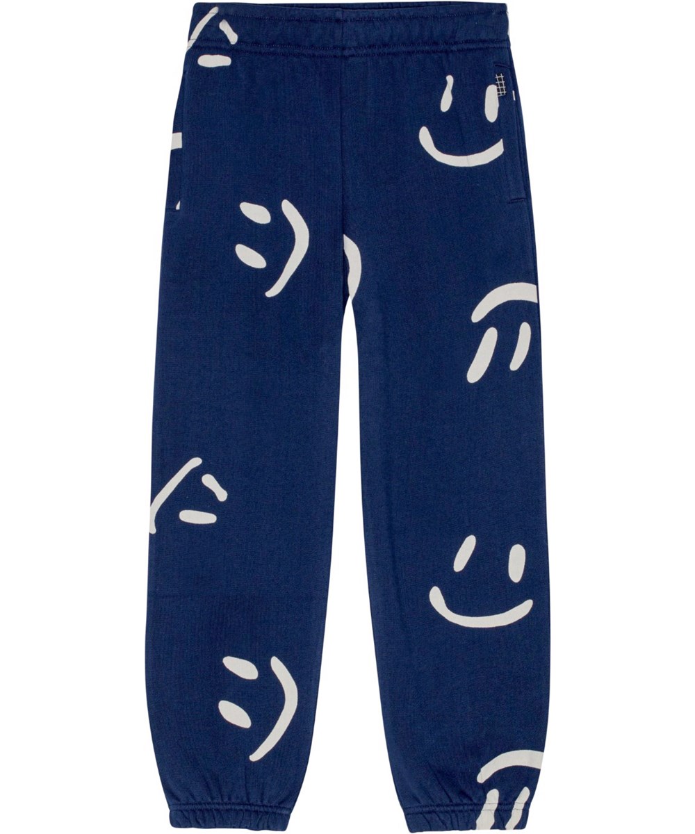 Adan - Big Smiles Navy - Dark blue organic cotton sweatpants with all-over white smile print.