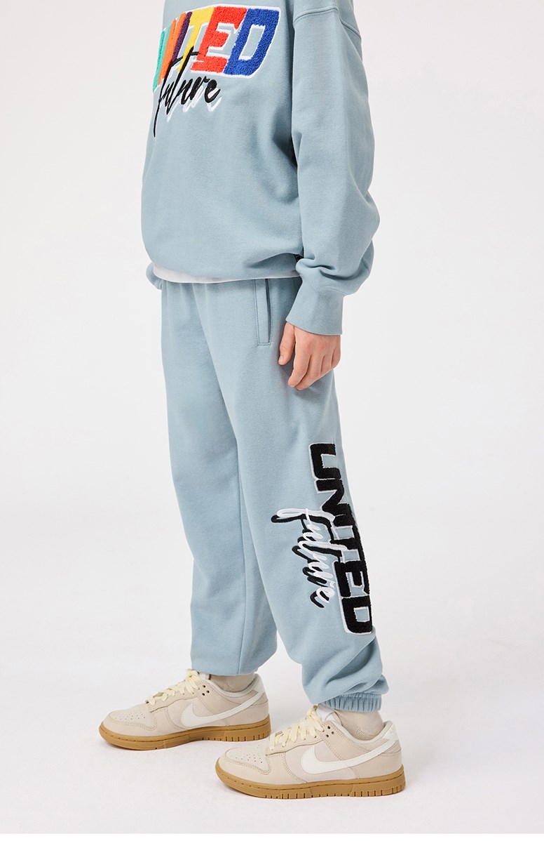 Allen - Misty Blue - Light blue organic cotton pants with 'United Future' print for children.