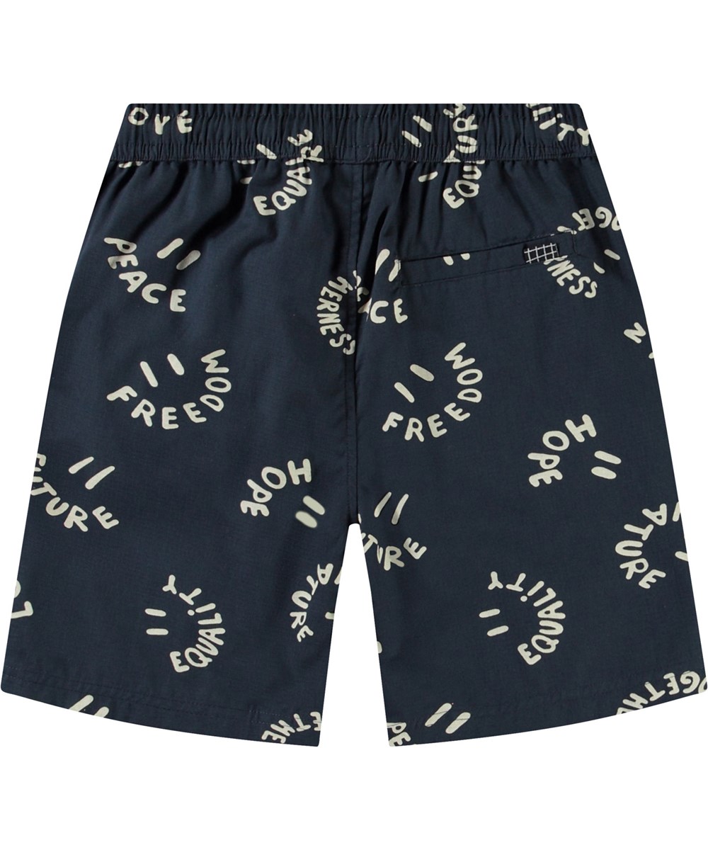 Avart - Smile Words - Knee-length shorts in organic cotton for children. These shorts are blue with smiling faces.