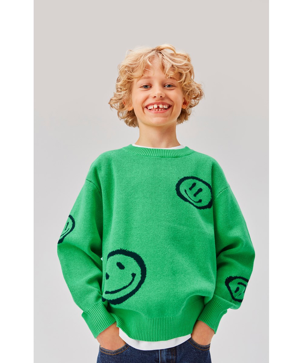 Bello - Smile On Green - Green knit jumper with smiley faces