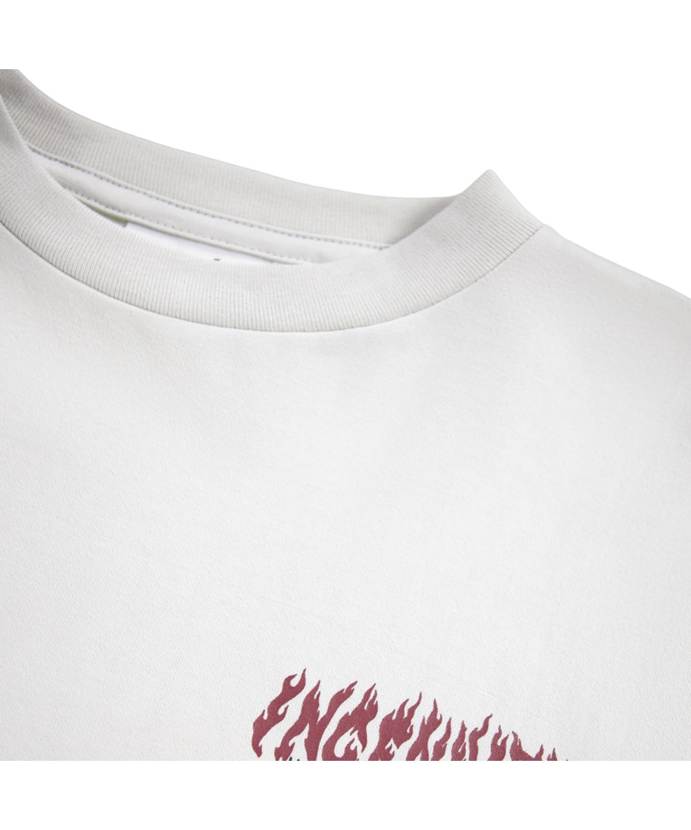 Rube - Ingenuity - Off-white long-sleeved top for children made of organic cotton with a ribbed neckline and sleeves with a print of the red flaming text ''Ingenuity, humankind freedom''.