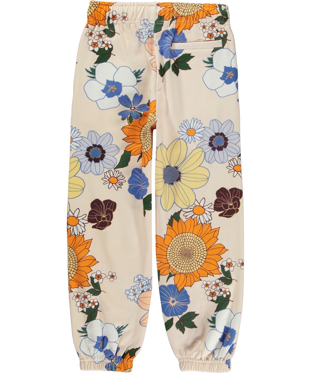 Adan - Light Retro - Råvita ekologiska joggingbyxor med grafiskt blommigt mönster.