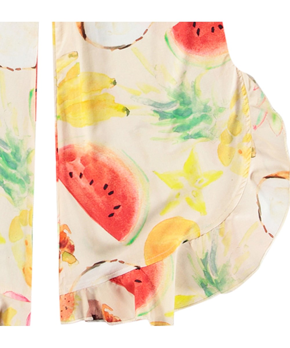 Aretha - Painted Fruits - Luftiga byxor för barn med volangkant tillverkade av ekologisk bomull.