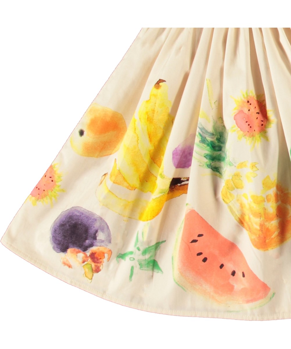 Bonnie - Dancing Fruits - Beige knälång bomullskjol med fruktmönster för barn.