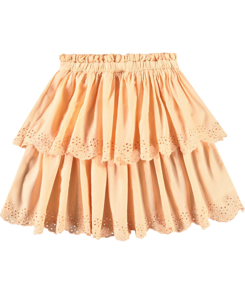 Brianna - Pale Melon - Ljusorange kjol i ekologisk bomull för barn. Kjolen är knälång och har två kjolar i olika längder med broderie anglaise längs kanten.