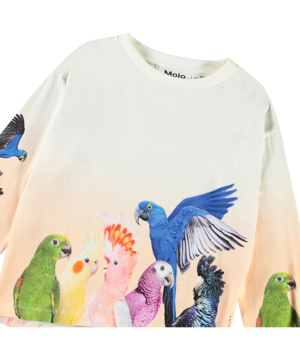 Reniza - Group Of Parrots - Ljusbeige och ljusorange långärmad topp med tryck för barn i mjuk ekologisk bomull med muddar och ribbad halsringning.