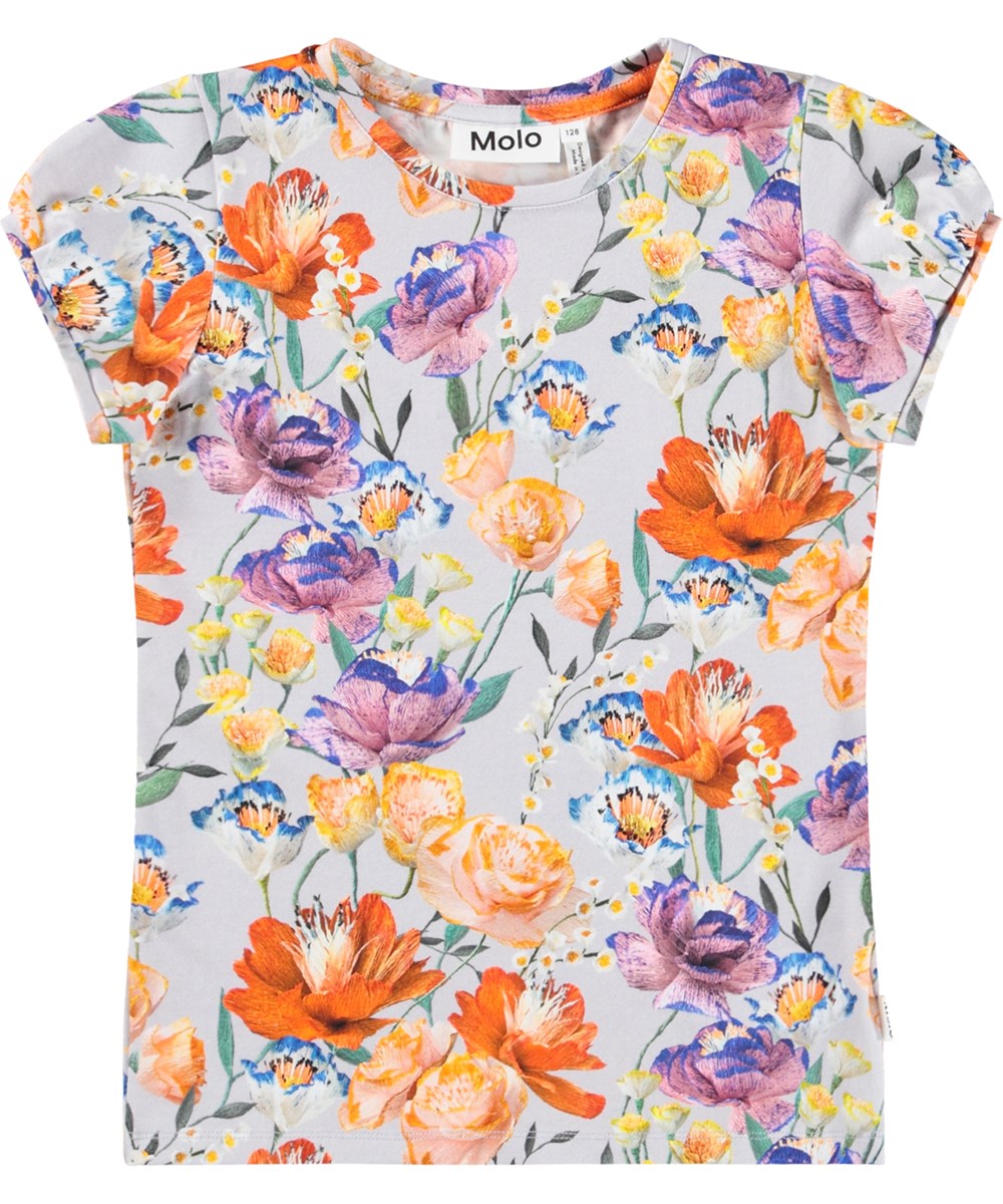 Rimona - Paper Flowers - Ljusblå, figursydd T-shirt för barn i mjuk ekologisk bomull med en rund hals och små korta puffärmar. T-shirten har ett färgglatt mönster av pappersblommor.