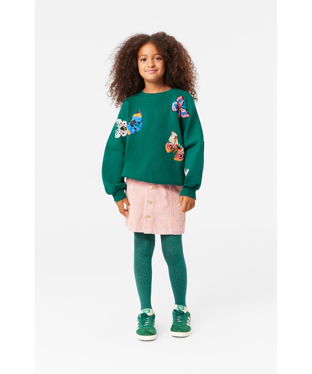 Marika - Aventurine - Mörkgrön sweatshirt i mjuk ekologisk bomull med multifärgade paljetter broderade som fjärilar.