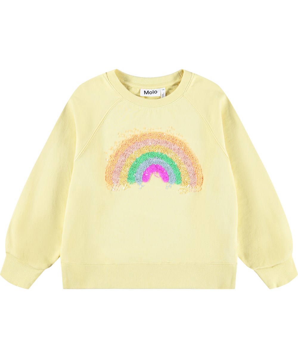Marilee - Mellow Yellow - Ljusgul tröja för barn i ekologisk bomull med en paljettregnbåge.