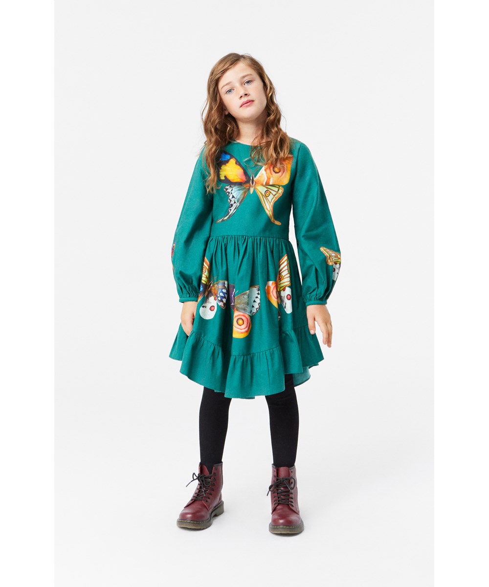 Calissa - Curiosum - Green cotton dress with round neckline, long sleeves, and butterfly print.
