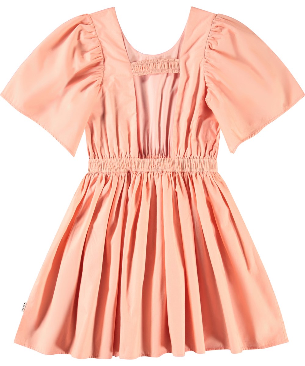 Cally - Peach - Light orange knee-length dress for children in organic cotton with a round neckline.