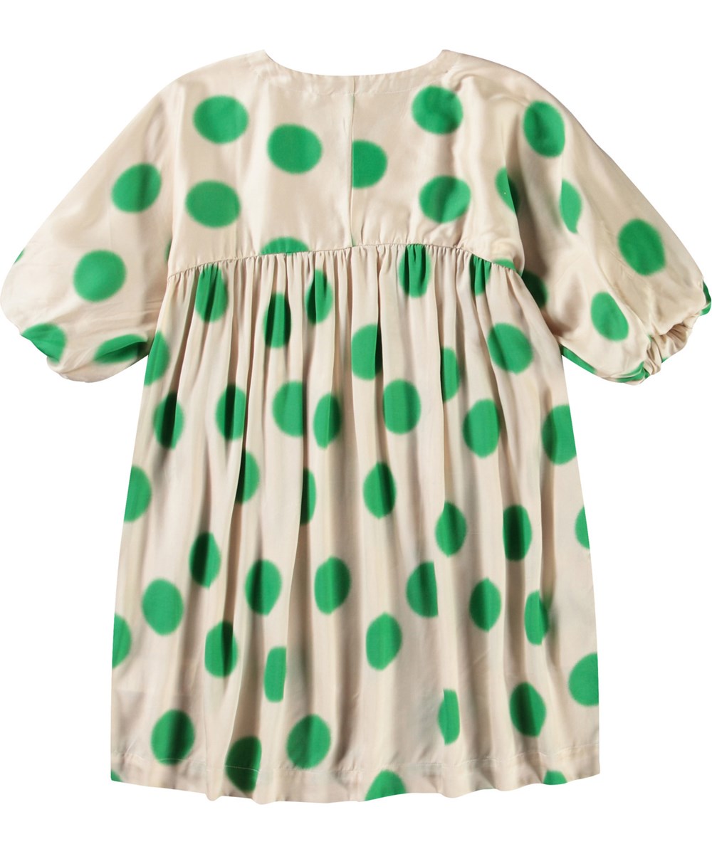 Camellia - Green Dots - Beige dress for children in viscose with a V-neck and large green dots.