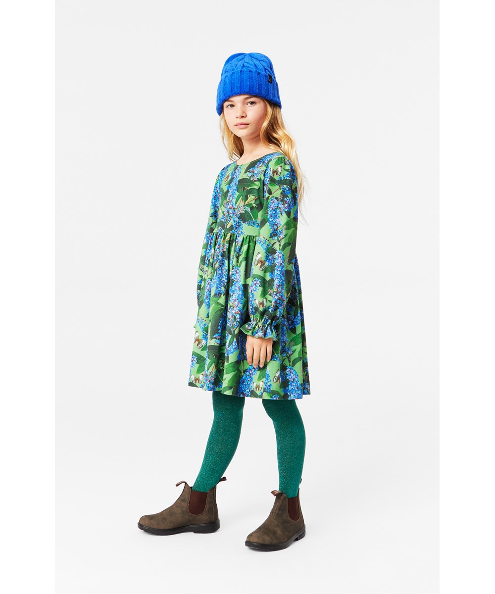 Camie - Buddleja Garden - Loose-fitting green organic cotton dress with ruffle sleeves and butterfly print.