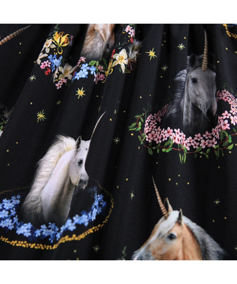 Camie - Magical Galaxies - Black jersey dress for children made of organic cotton with a print of unicorns and flowers.