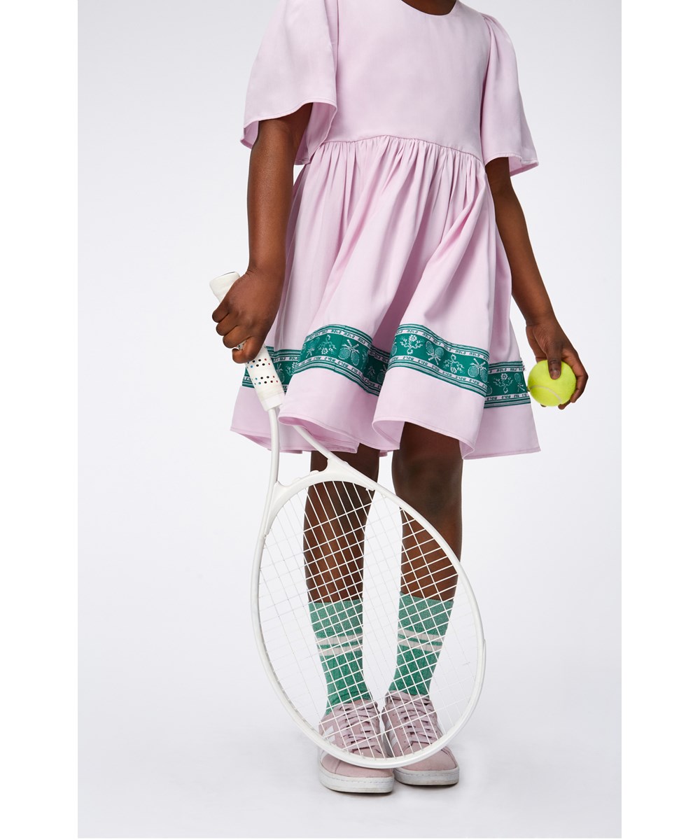 Carlin - Alpine Glow - Pink viscose dress with a green, printed border with flowers and tennis racquets