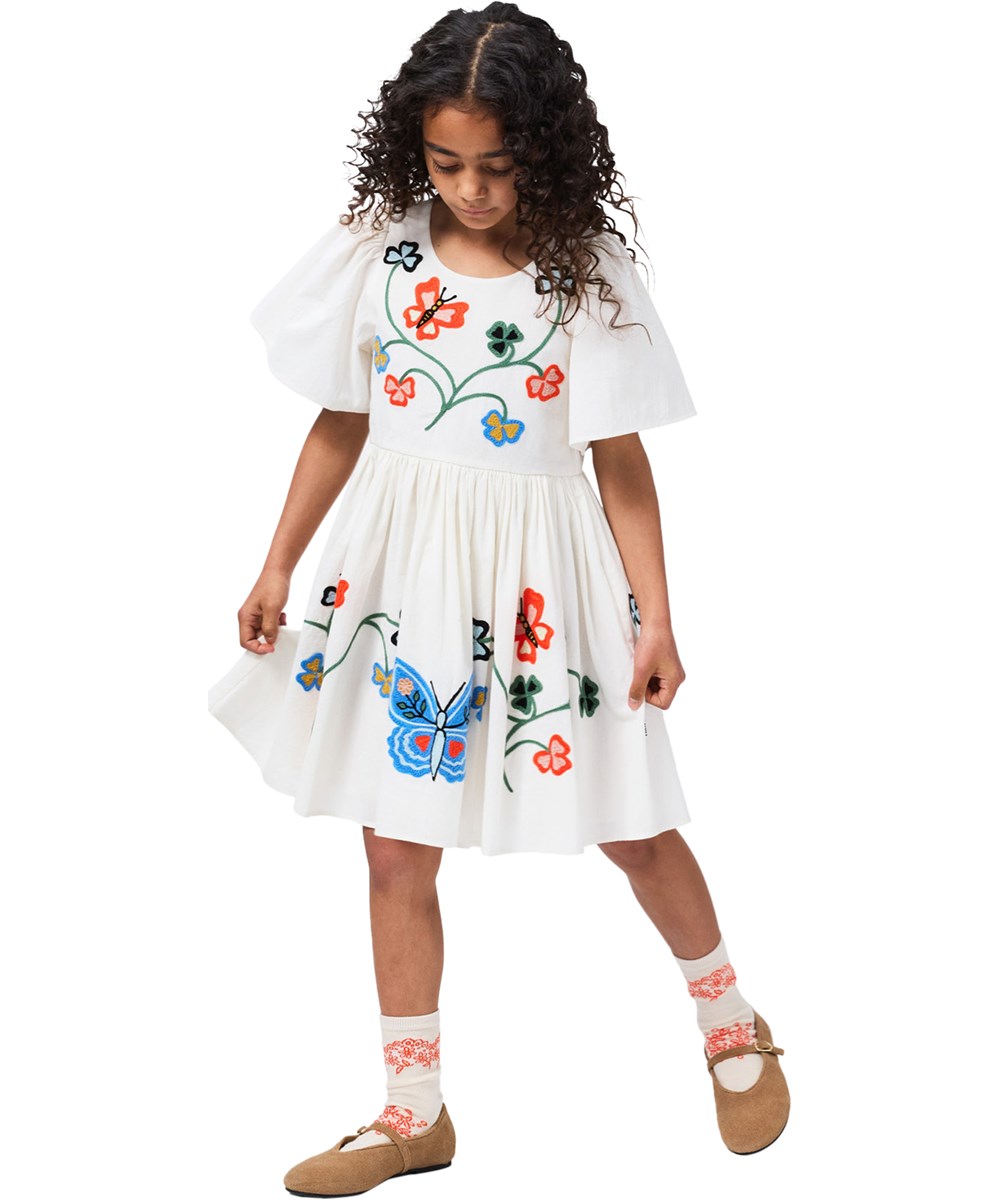 Carlin - Nature Border - Off-white dress for children made of organic cotton with a butterfly embroidery