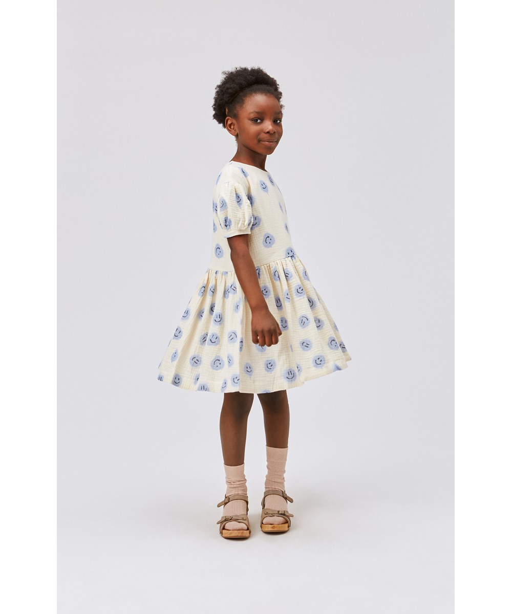Cascadia - Crisp Smiles - Light coloured dress with puff sleeves and smiley faces print