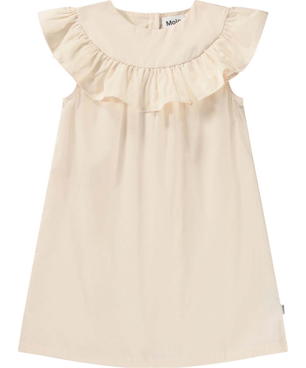 Celia - Brazilian Sand - Knee-length beige A-line dress with ruffle detail on the shoulders and button fastening at the back of the neck.
