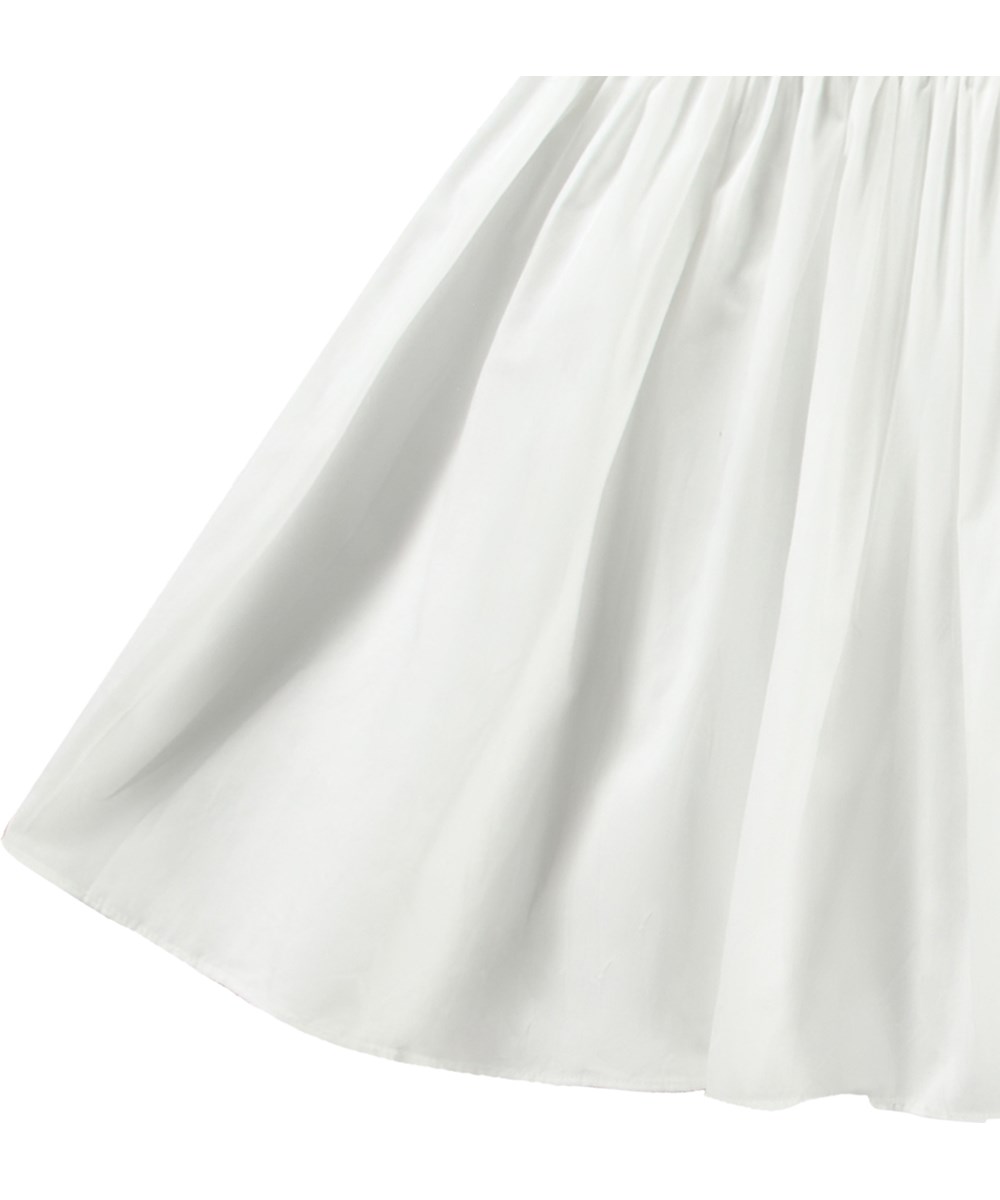 Chloey - Crisp White - White one-shoulder dress in organic cotton with a wide poplin ruffle.