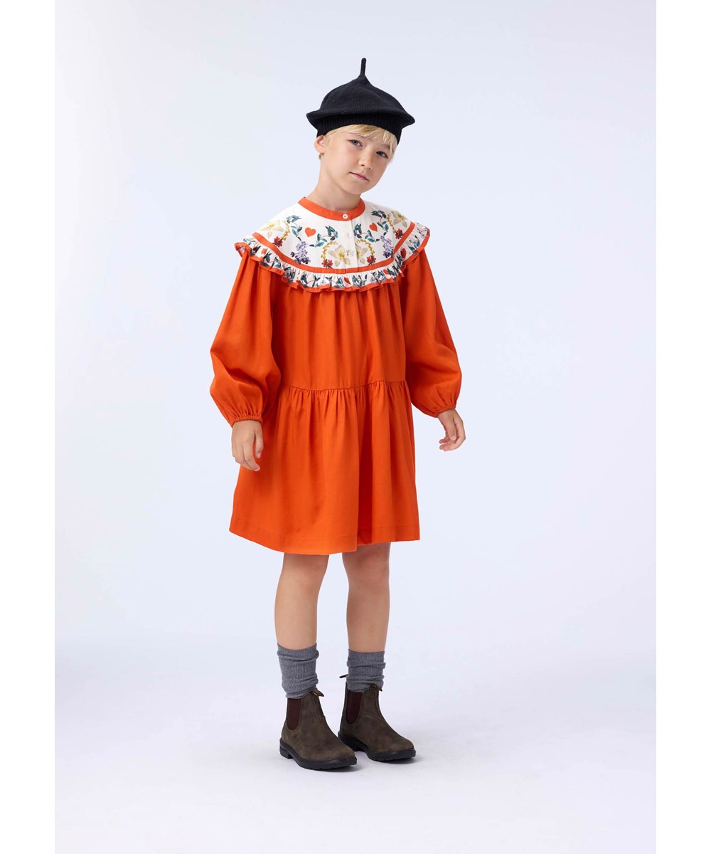 Cibbe - Alpine Flora - Orange knee-length dress for children made of viscose with a print of flowers on the yoke.
