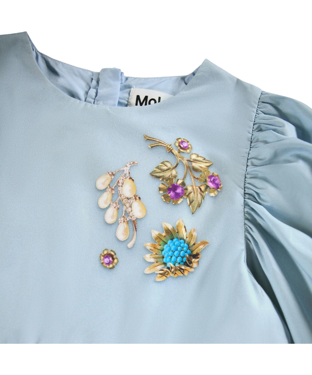 Cilja - Broches - Knee-length light blue dress for children made of organic cotton poplin with a print of jewelry.