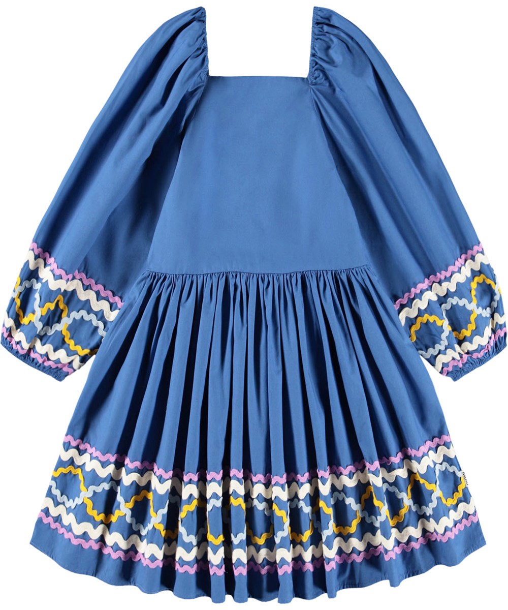 Ciris - Mystic Blue - Blue dress for children made of organic cotton with colorful zig-zag ribbons as a nice detail.