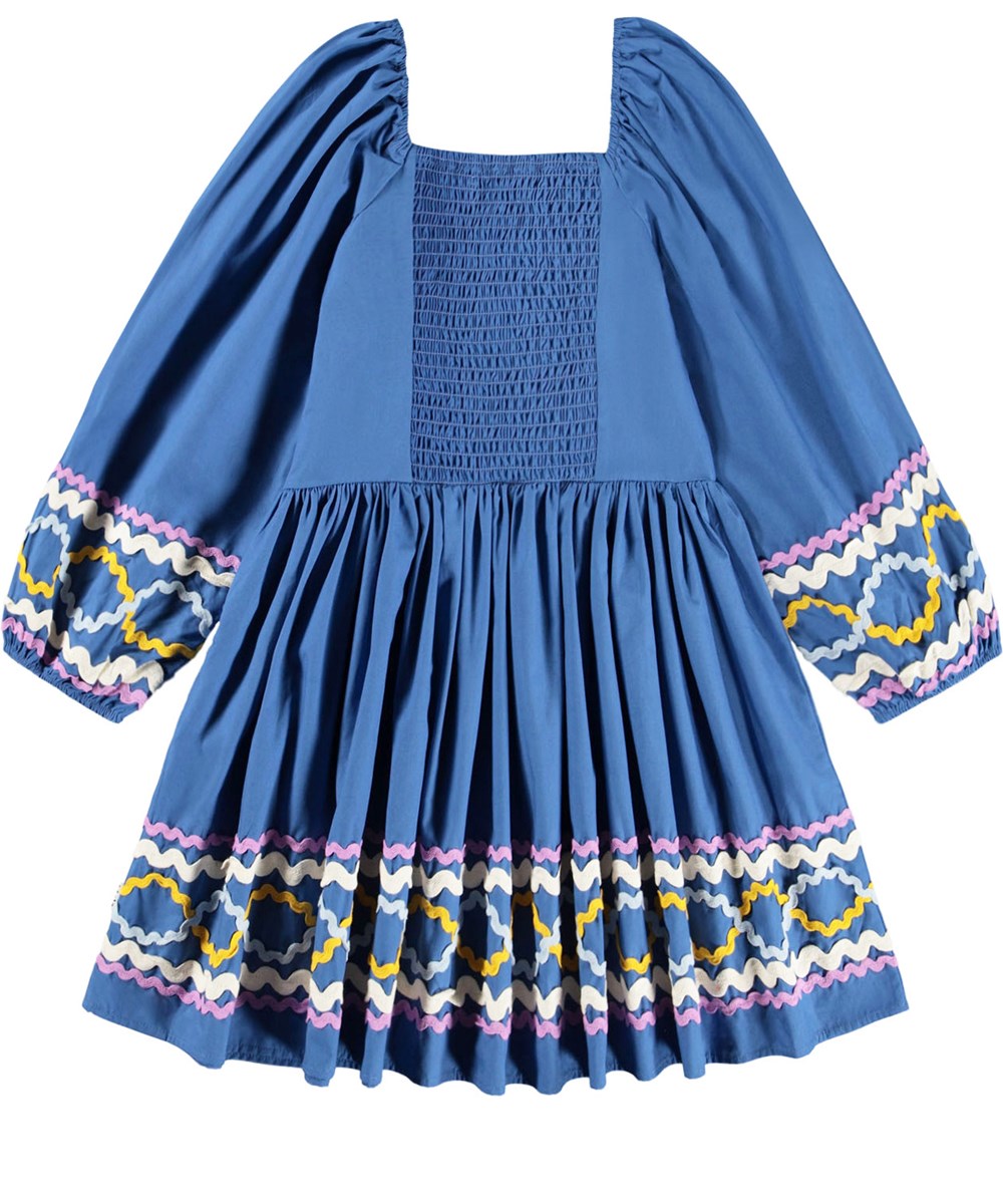Ciris - Mystic Blue - Blue dress for children made of organic cotton with colorful zig-zag ribbons as a nice detail.