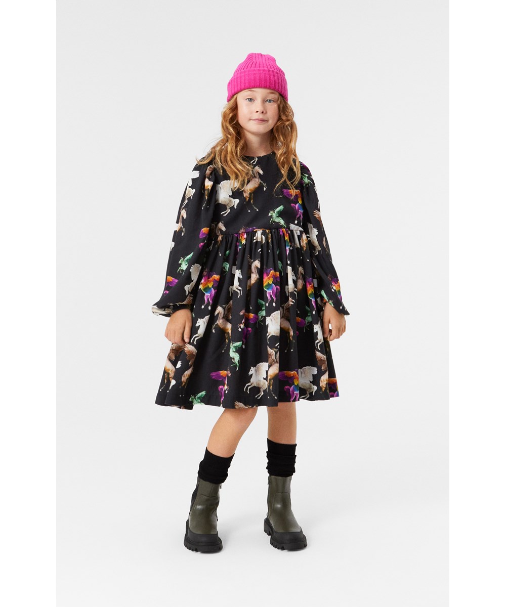 Cocos - Flying Pegasus - Elegant black knee-length dress with oversized fit and ruffled details.