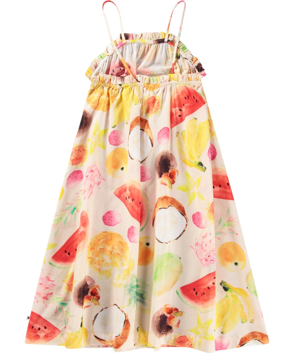Connie - Painted Fruits - Beige loose dress for children in organic cotton with a print of colourful exotic fruits, thin straps, and frilled edge.