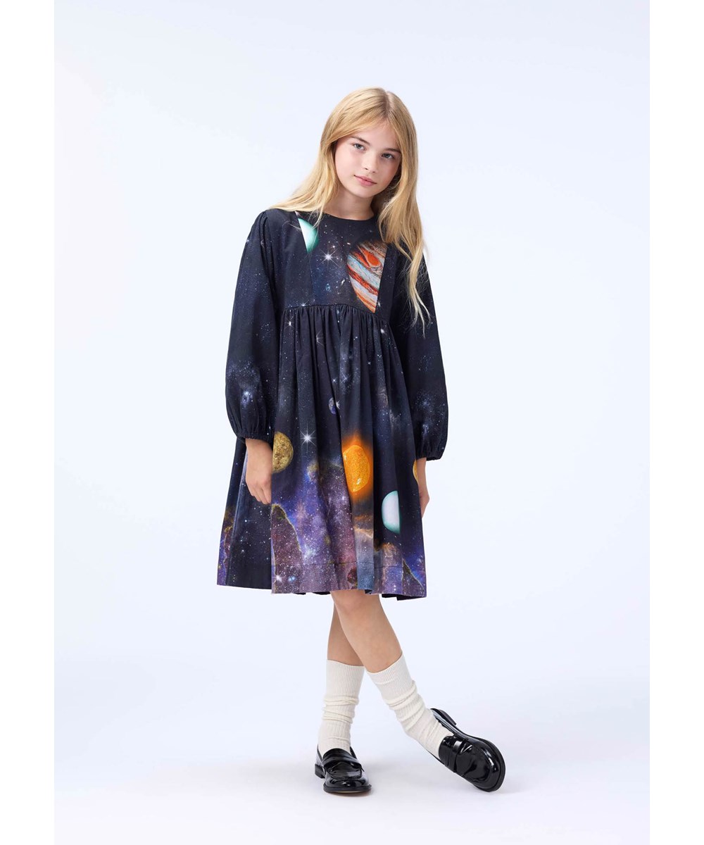 Crystal - Made Of Stardust - Knee-length dark dress for children made of organic cotton with a print of the universe and planets.