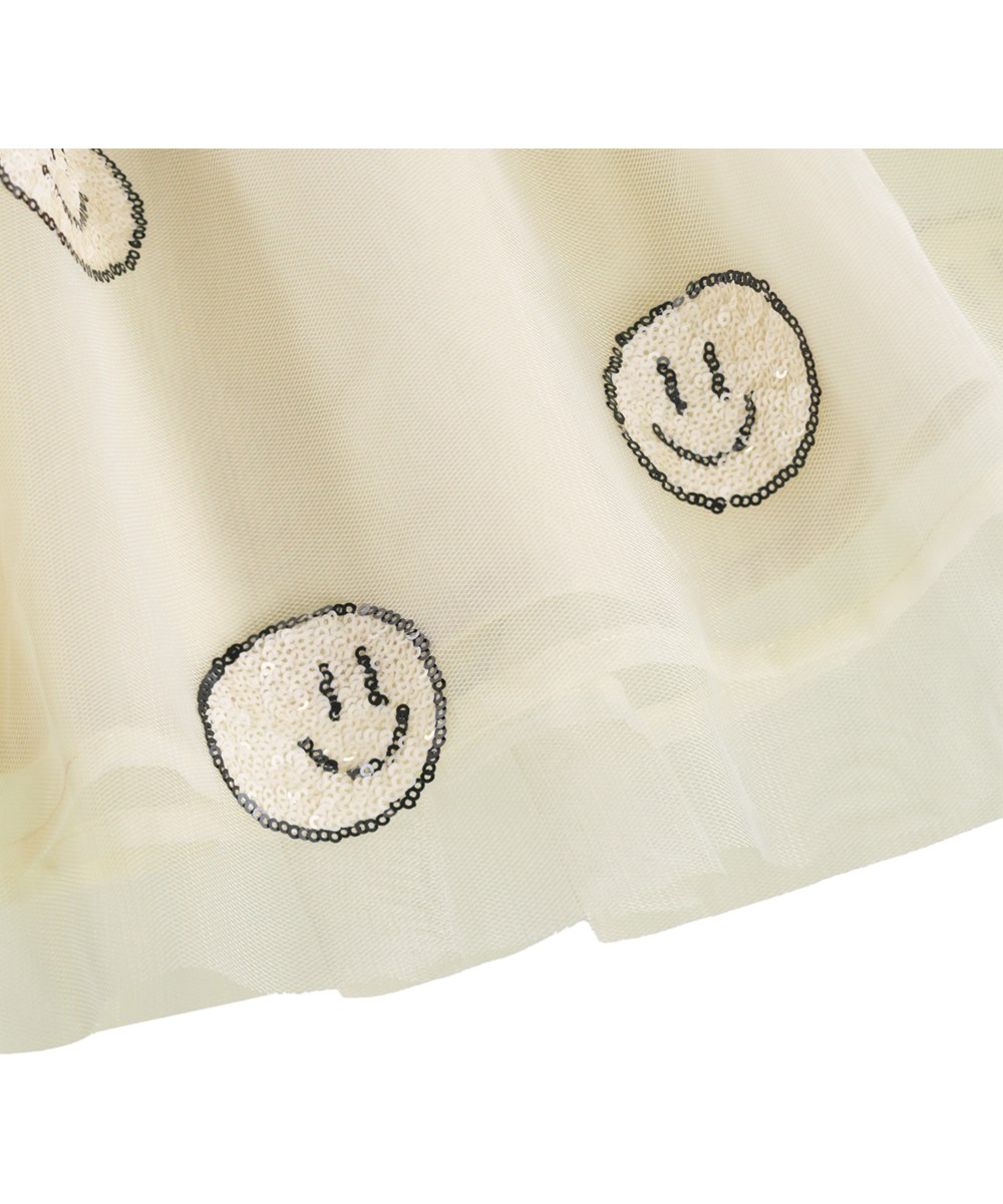 Cyrus - Summer Sand - Off-white dress for children with long sleeves and a tulle skirt with cheerful sequin flowers
