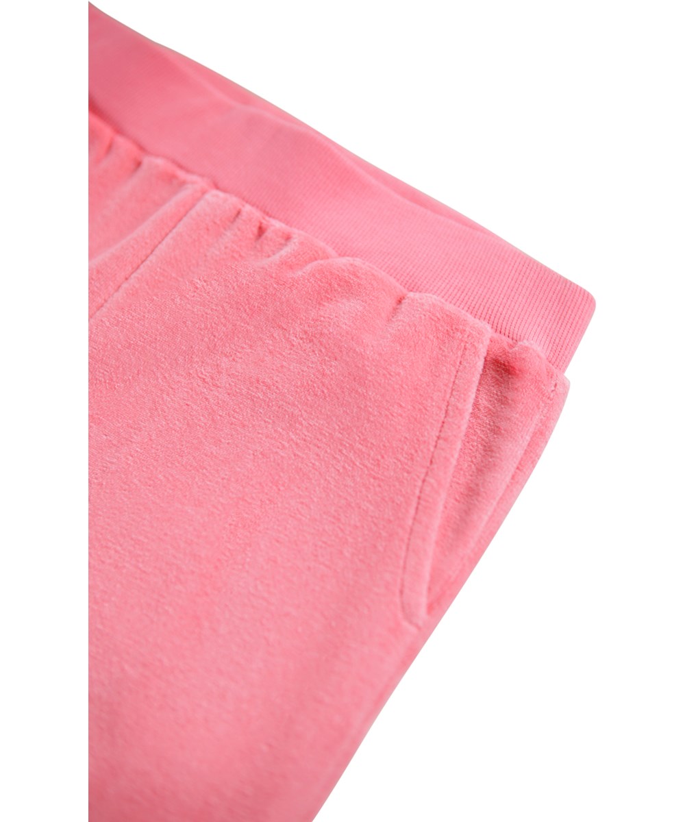 Adoria - Confetti - Pink velour pants for children made of a soft cotton blend in a trumpet shape.