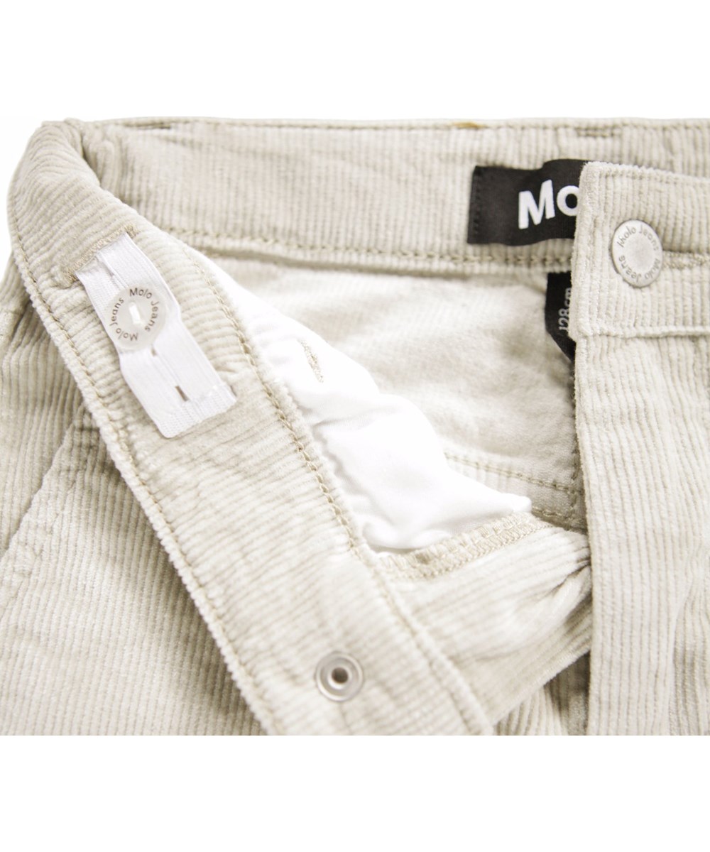 Aida - Quiet Grey - Off-white pants for children made of soft cotton velvet in a trumpet-shaped silhouette.