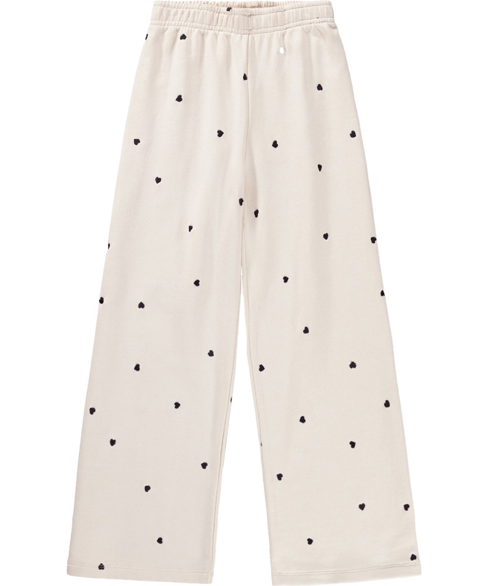 Anna - Confetti_Sand - Off-white trousers for children made of organic cotton jersey with an elastic waistband 