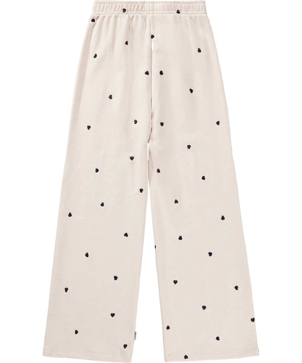 Anna - Confetti_Sand - Off-white trousers for children made of organic cotton jersey with an elastic waistband 