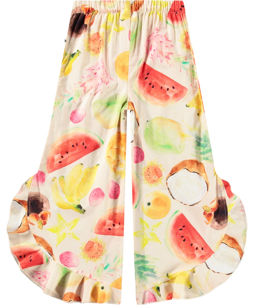 Aretha - Painted Fruits - Airy pants for children with ruffle edge made from organic cotton.