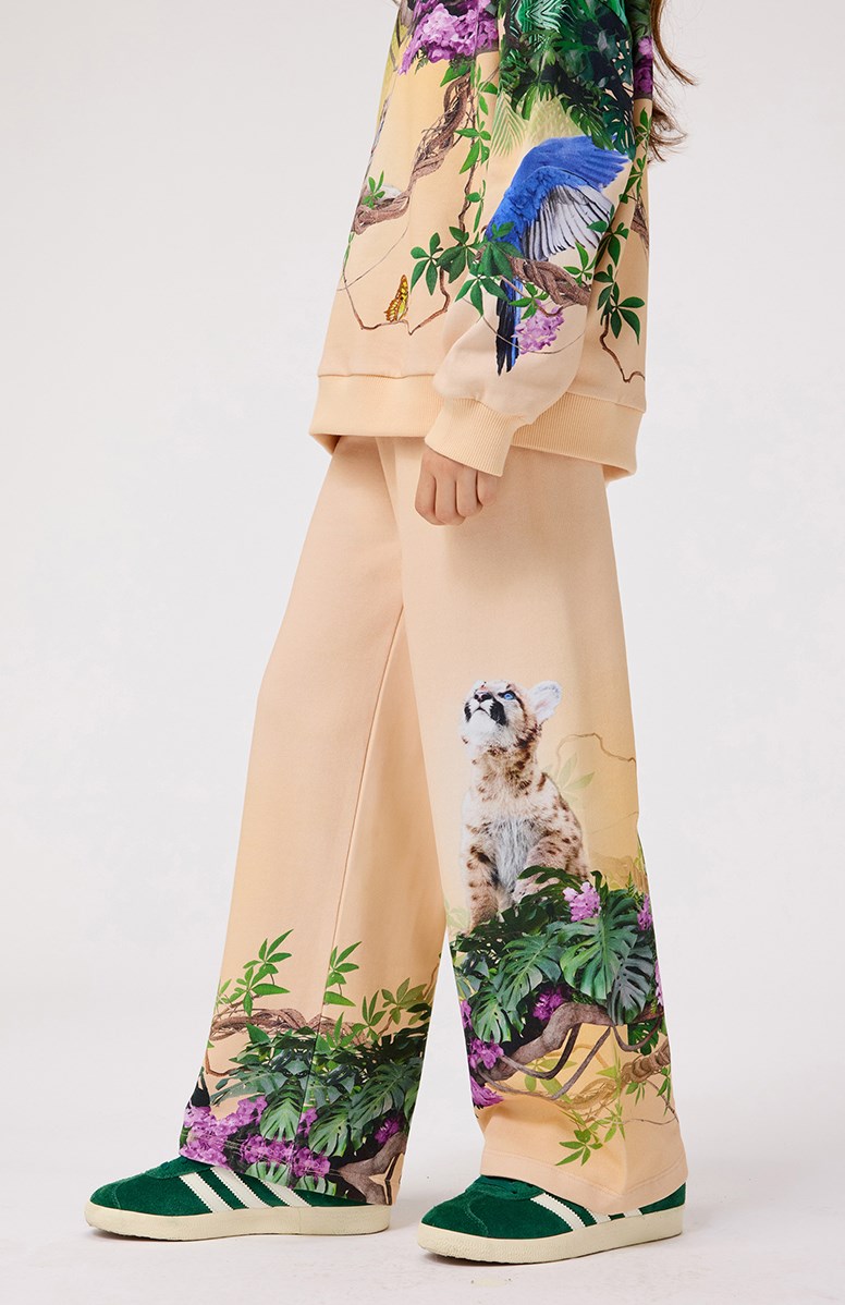 Aurita - Pumatastic - Light orange jersey pants made from organic cotton, featuring a jungle animal print for children.